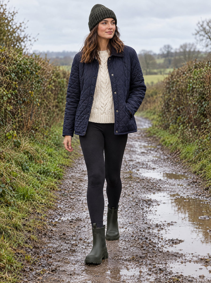 The Cherry Drop rain boots in Orchard, worn with a quilted jacket and leggings